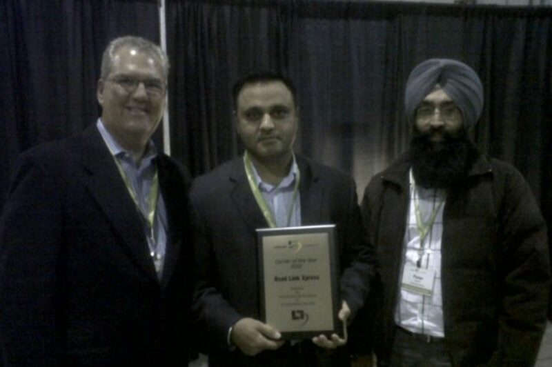 (L-R) Jeff Moore, managing director of Lakeside Logistics presents the Carrier of the Year award to Road Link Xpress's Raj Dhaliwal, co-owner and Peter Sandhu, dispatcher.