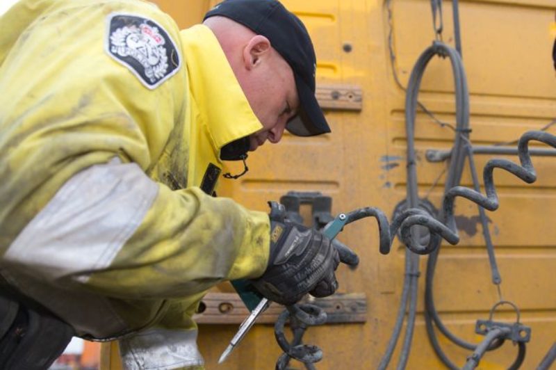 Const. Ken Usipiuk inspects a truck at Harbour Link Container Services' facility in Delta, B.C. Photo by The Delta Optimist.