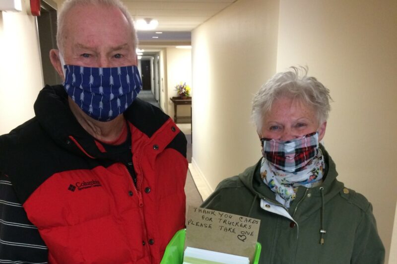 Grateful senior hands out thank you cards to truckers article image