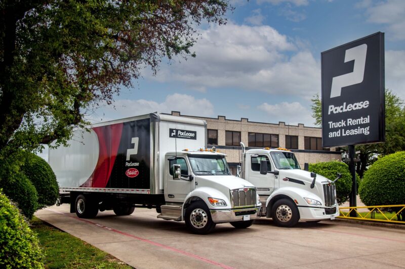 PacLease trucks parked in front of sign