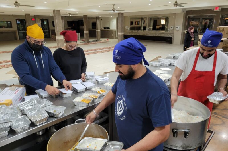 Volunteers pack meals