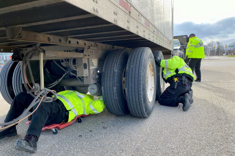 Police officers inspecting a truck