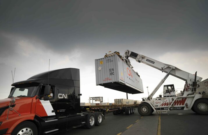 Picture of a CN truck being loaded with a container.