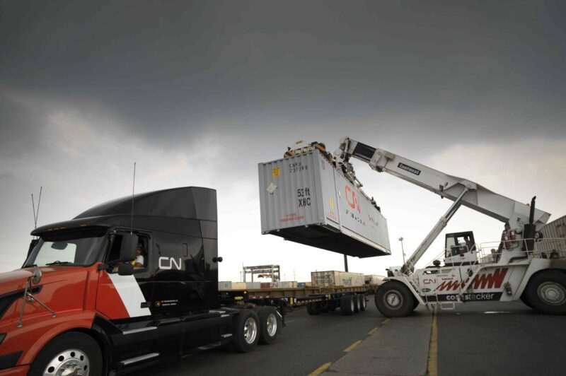 Picture of a CN truck being loaded with a container.