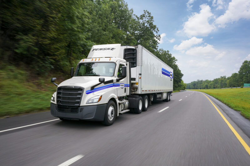 Picture of a Penske truck on a road.