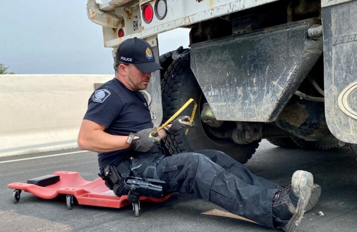 Police officer with a tapemeasure