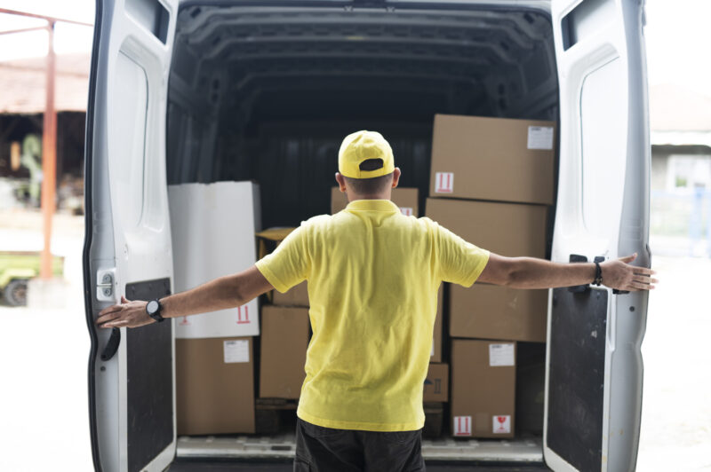 Man opens rear doors of delivery van