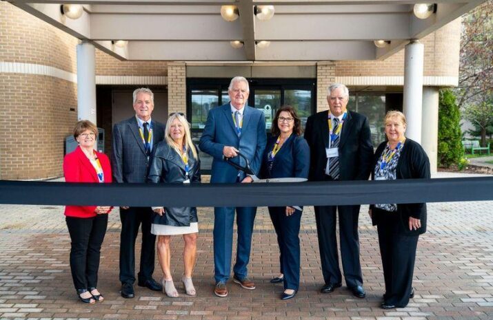 Verspeeten family cutting the ribbon at the opening of its family cancer center