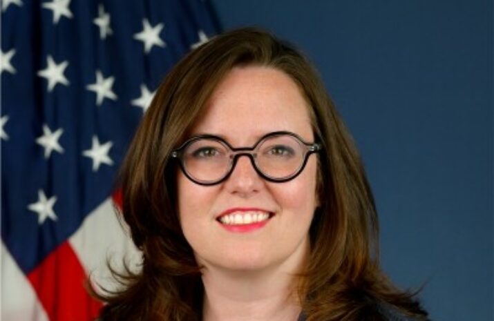 Headshot of Melody Drummond Hansen with US flag