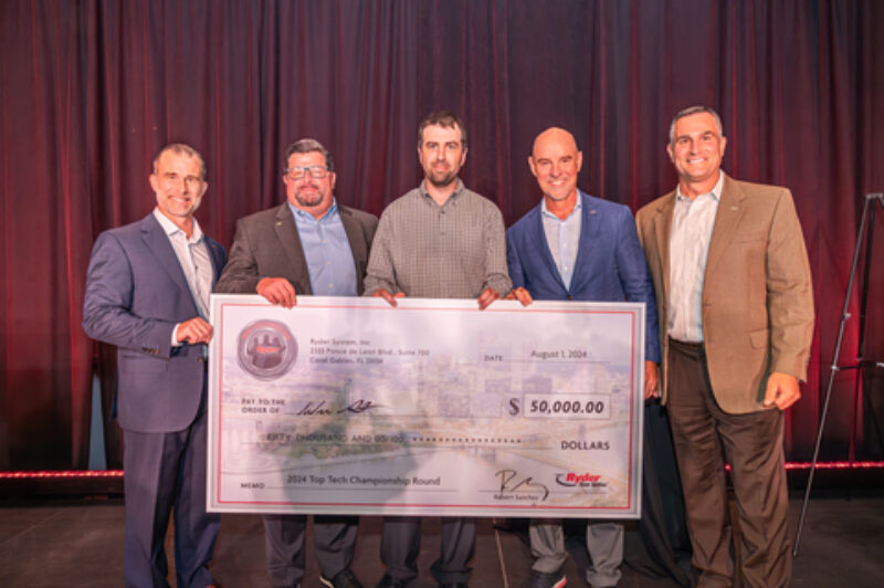Ryder's top tech competition winner holding a cheque