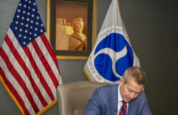 Photo of Duffy signing his first memo