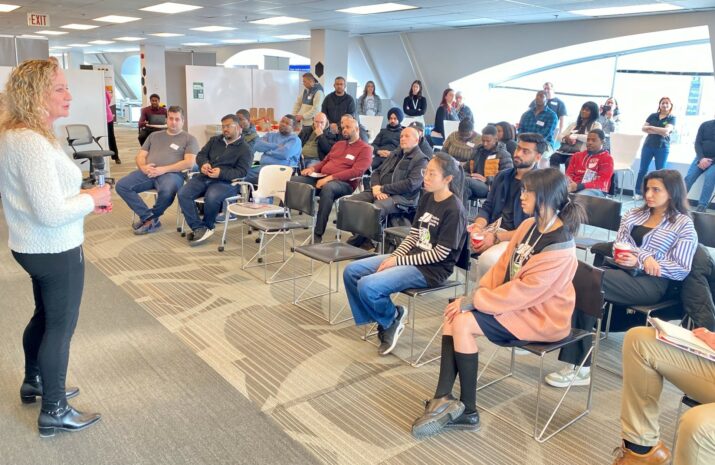 A woman talks to a seated audience