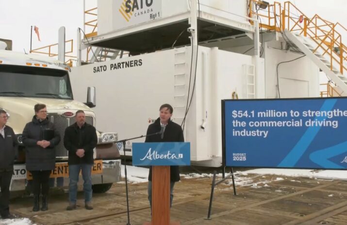 Picture of men in front of a truck