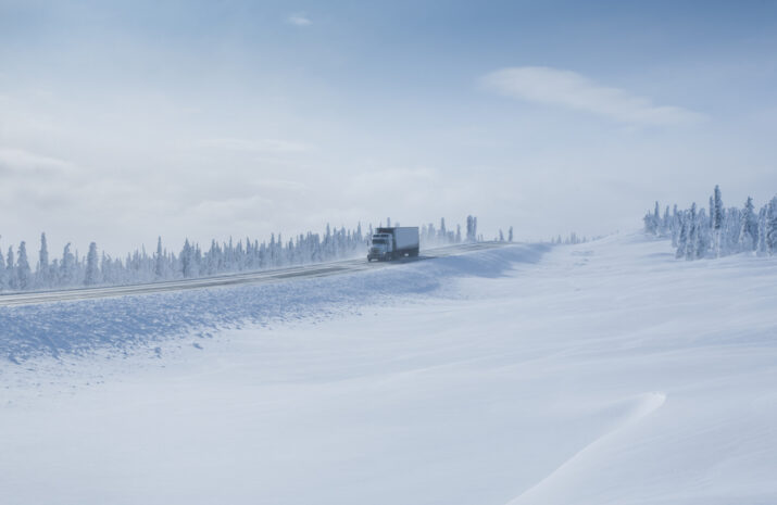 Big Rig Semi-Truck driving on an Arctic Winter Highway in Alaska