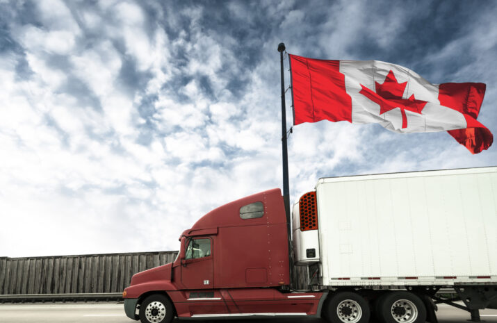 Picture of a truck and large Canadian flag