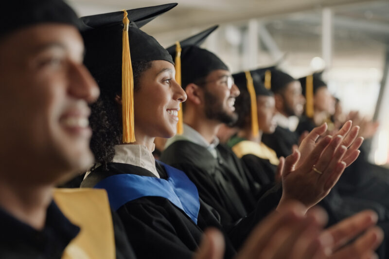 Student, university and graduation clapping or ceremony celebration of education achievement, scholarship or college. Men, woman and diversity applause or academy support or study, victory or event