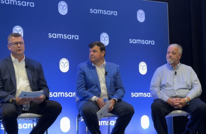 three panelists sitting on stage in front of Samsara backdrop
