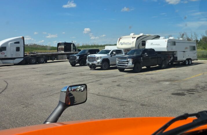 Picture of pickups hauling campers parked in truck parking spots