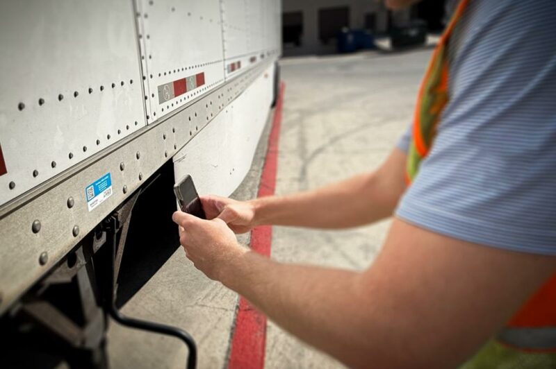 Picture of man with phone near trailer