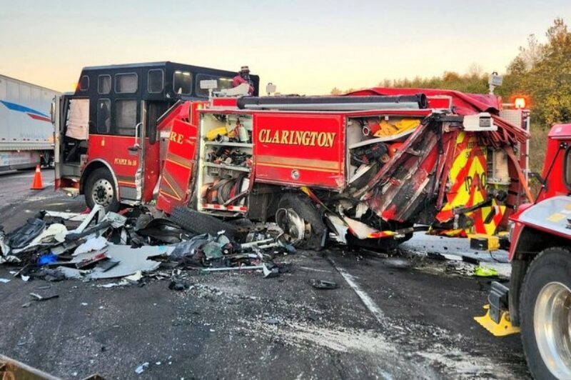 Picture of a damaged firetruck after it was hit by a tractor trailer