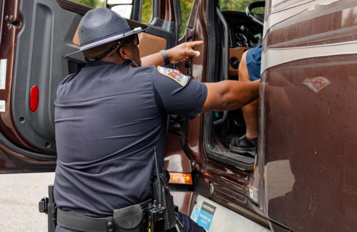An Alabama officer inspecting a truck