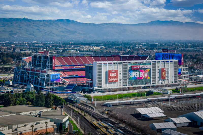 An aerial view of Levi's Stadium dressed for Super Bowl LX 2026 with a view of Santa Clara behind it.